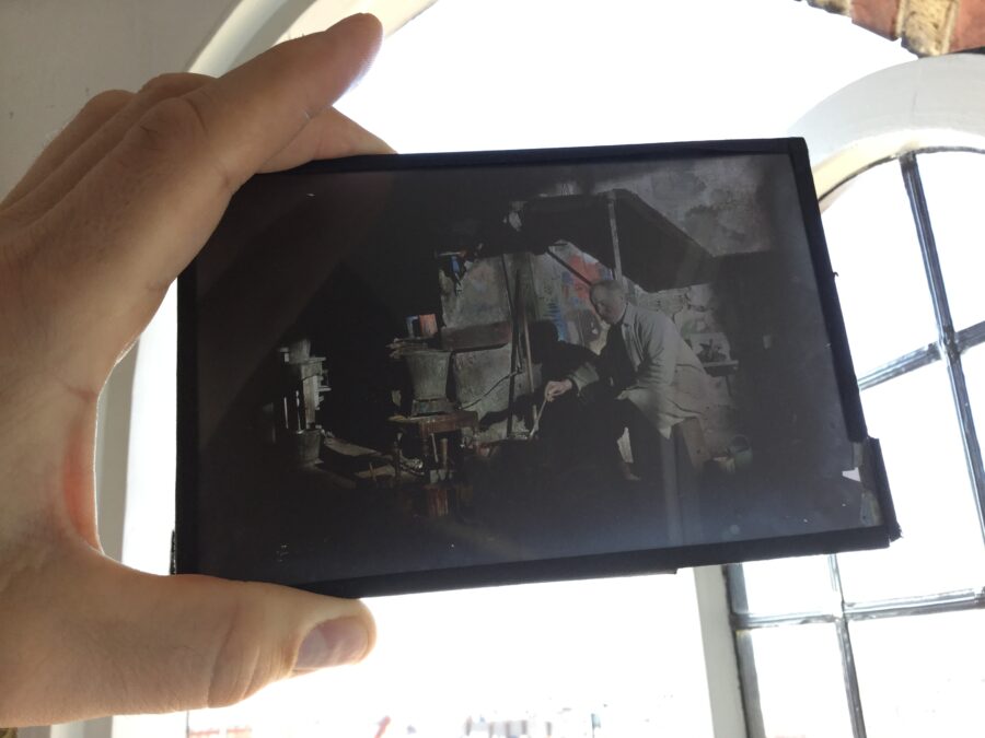 The Autochrome plate being held against the light The Autochrome plate being held against the light